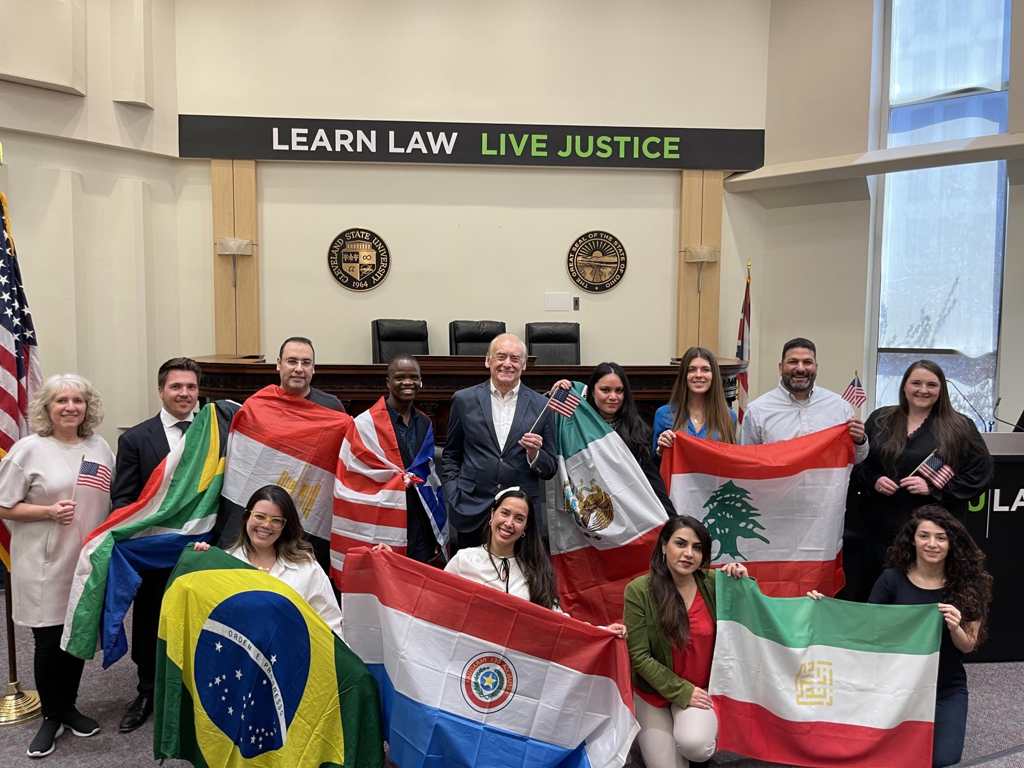 LLM Students holding flags from their nations