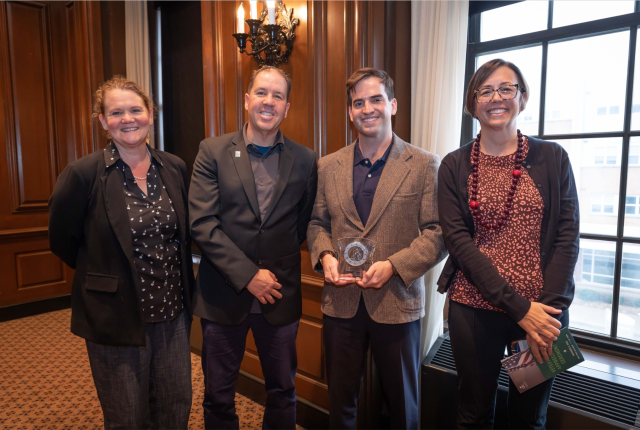 Law professors smiling with student receiving Veteran of the Year award