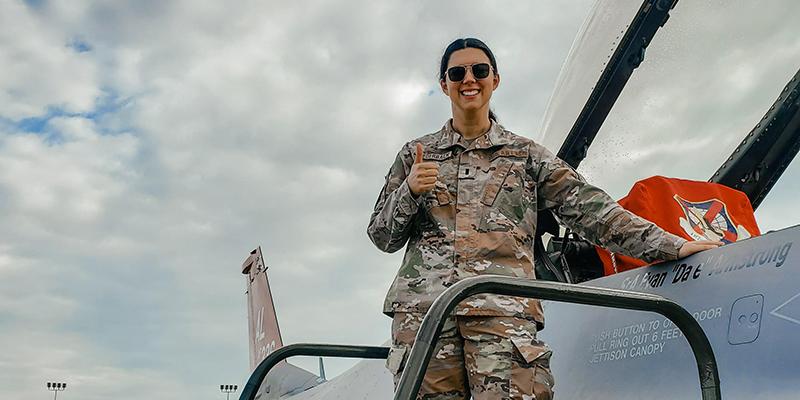 JAG officer on wing of plane smiling